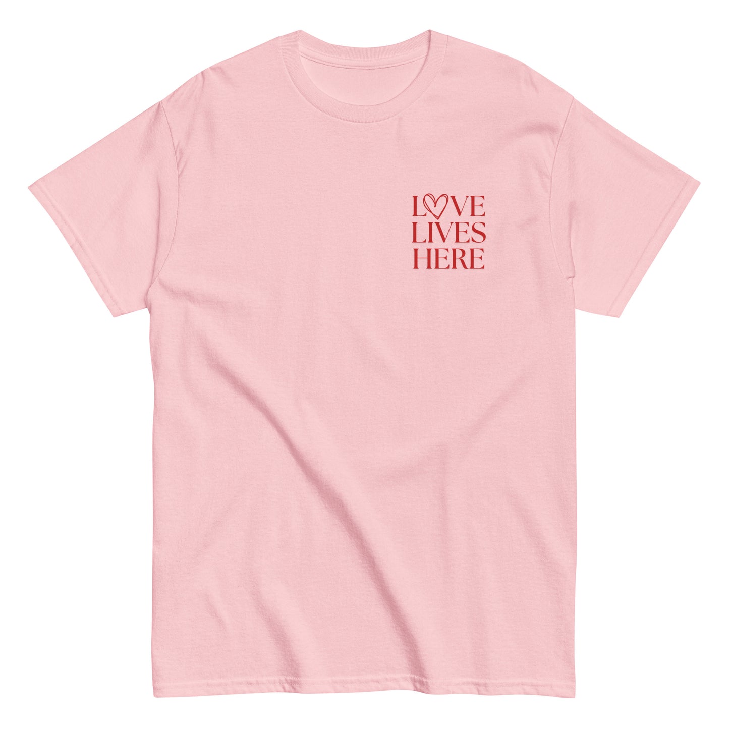 Love Lives Here T-Shirt in light pink with red lettering, a fashionable and meaningful t-shirt for those embracing love and compassion.