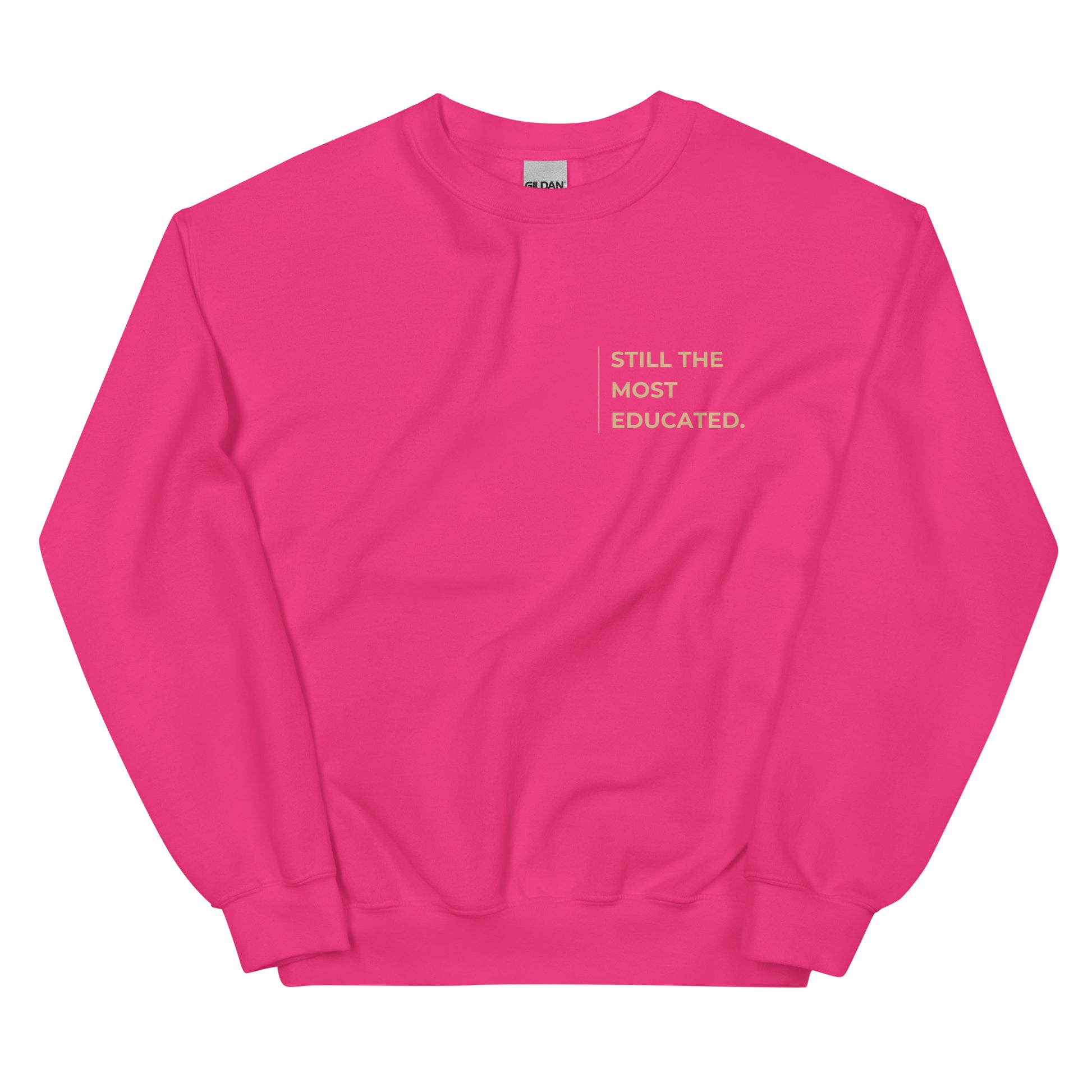 Still the Most Educated Sweatshirt in fuchsia with beige lettering, a vibrant and stylish pullover perfect for those embracing their brilliance.