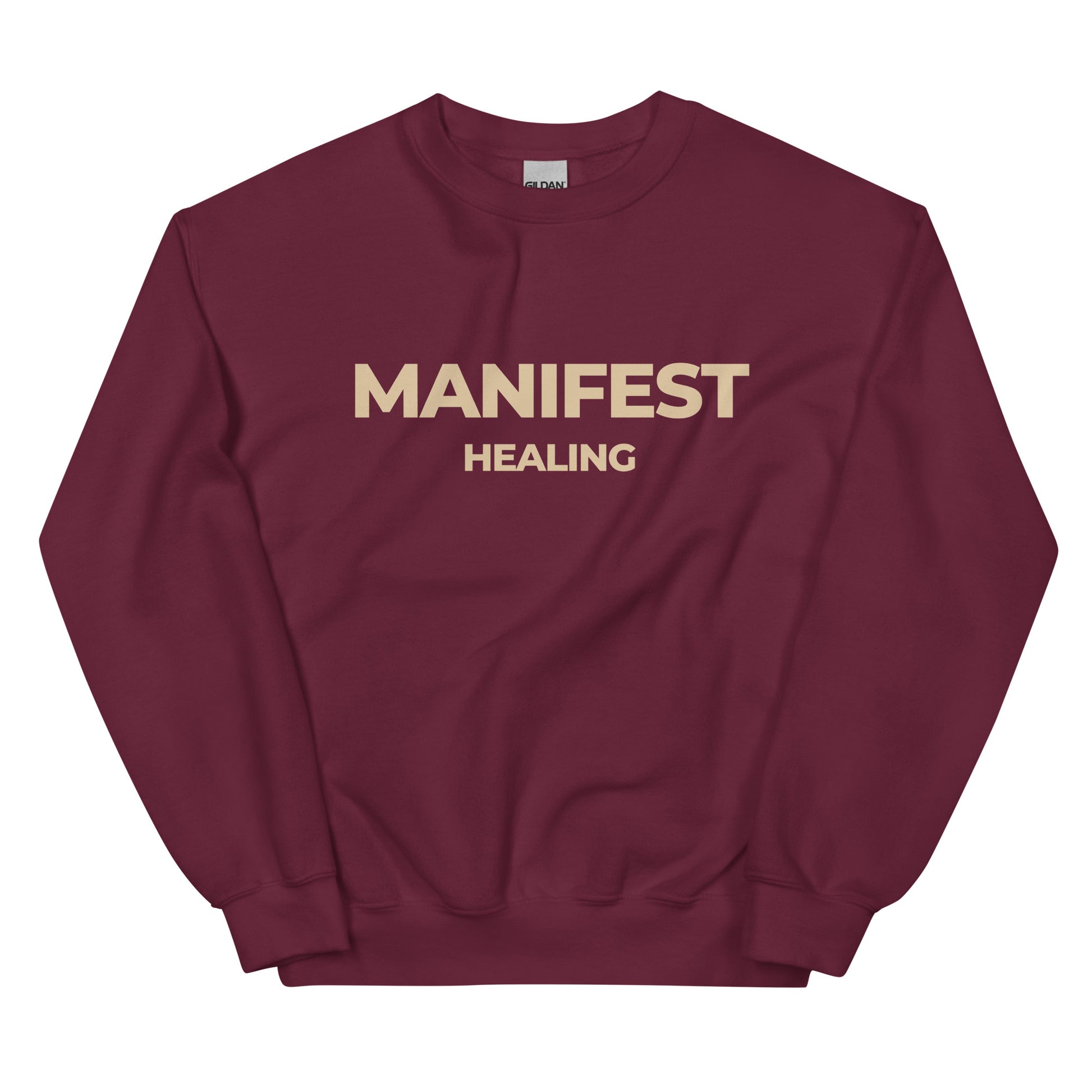 Manifest Healing Sweatshirt in burgundy with beige lettering, perfect for those embracing self-love and healing.