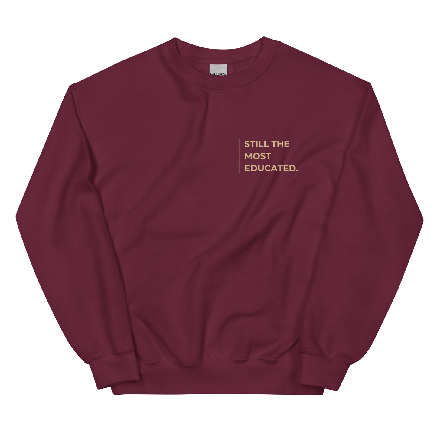 Still the Most Educated Sweatshirt in burgundy with beige lettering, an empowering pullover for scholars, professionals, and leaders.