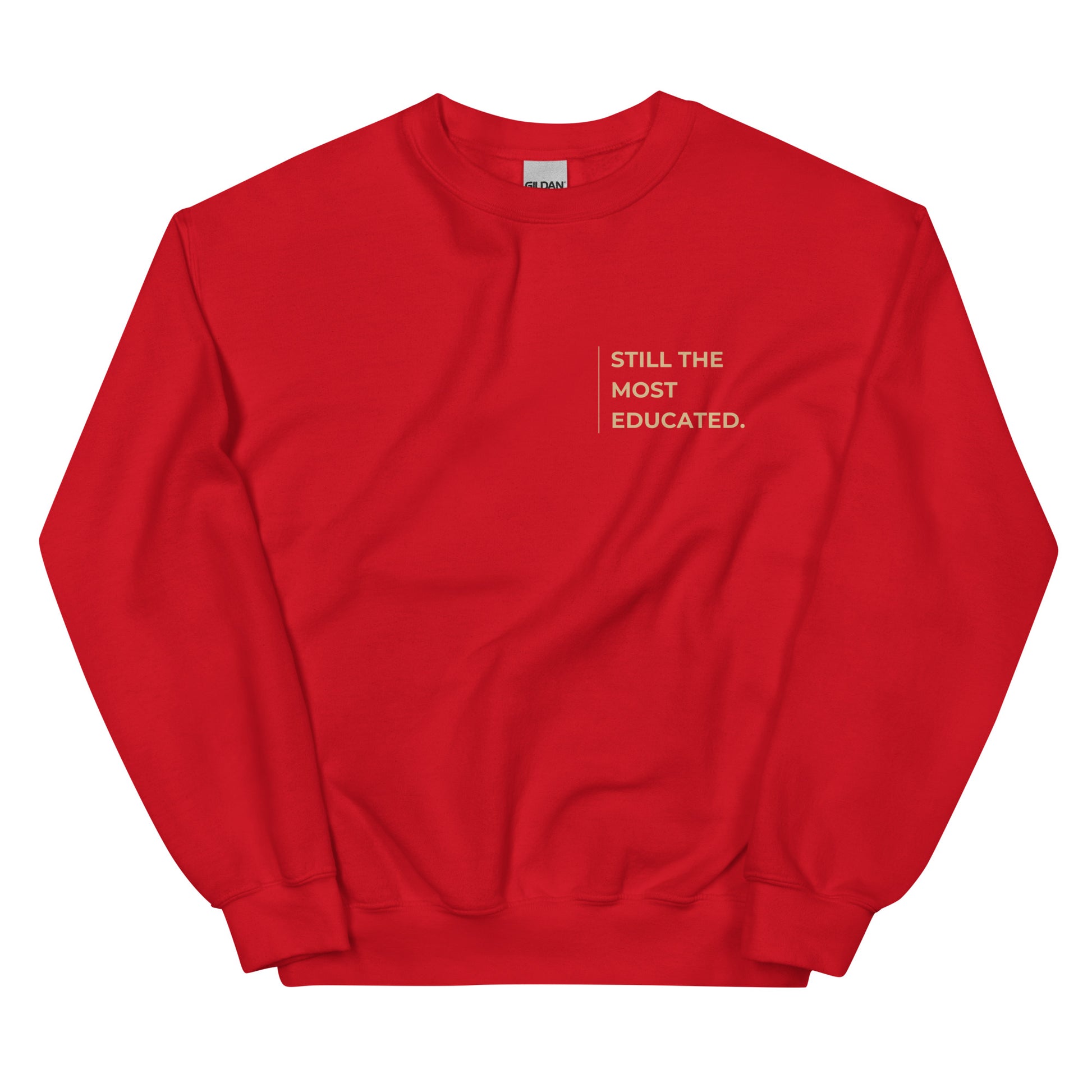 Still the Most Educated Sweatshirt in bold red with beige lettering, a striking pullover for those wearing their intelligence with confidence.